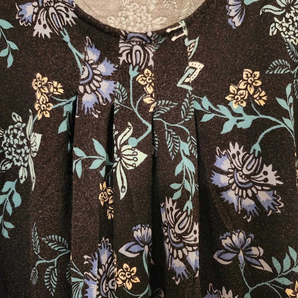 Floral Patterned tank top with pleated neckline. Black background